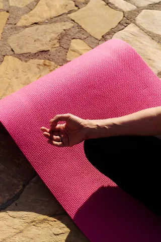 Yoga Mat and hand.  Photograph by Kristina Tochilko.