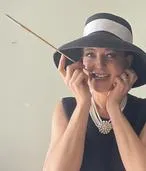 Leslie Goddard portrays Audrey Hepburn.